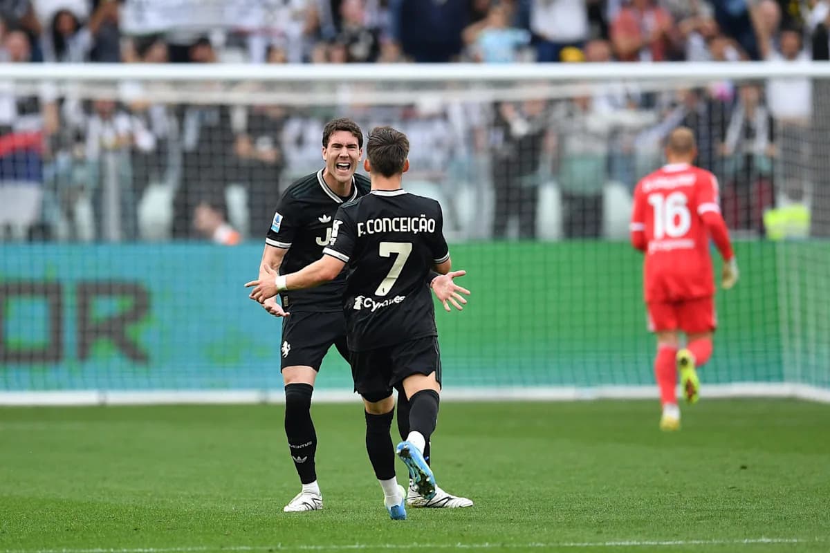 Two Juventus players celebrating a goal on field Two Juventus players celebrating a goal on field