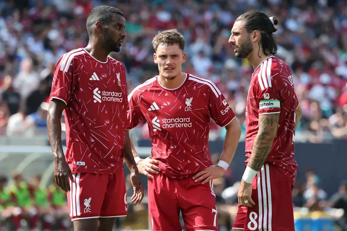 Liverpool players discussing strategy during a match Liverpool players discussing strategy during a match