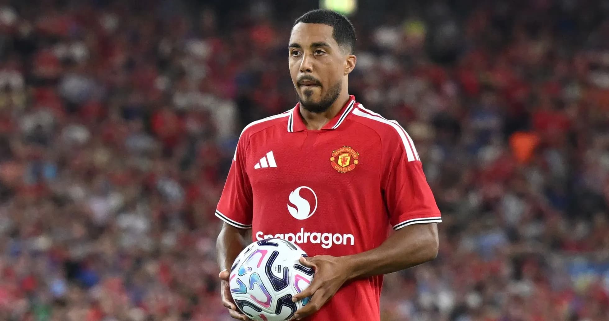 Player in Manchester United jersey holding a ball Player in Manchester United jersey holding a ball
