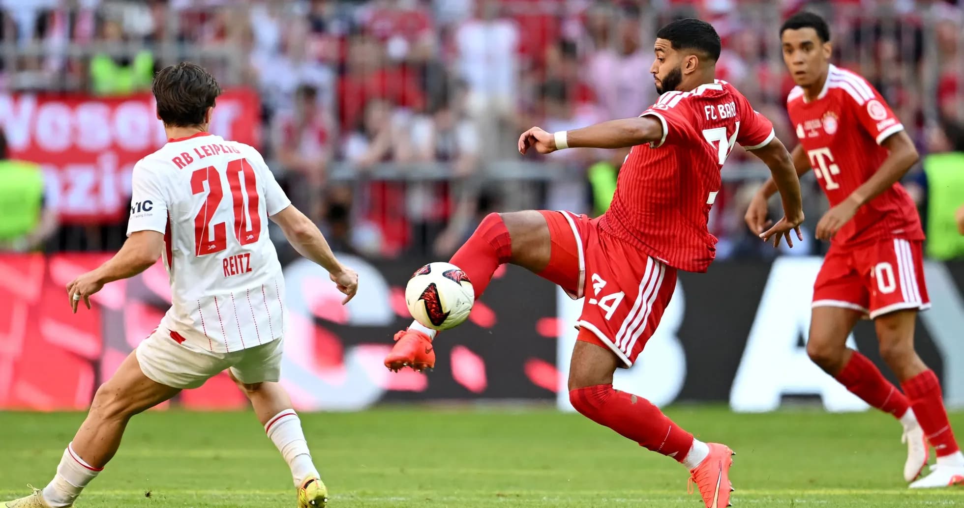 Player from RB Leipzig attempts to tackle Bayern Munich player Player from RB Leipzig attempts to tackle Bayern Munich player