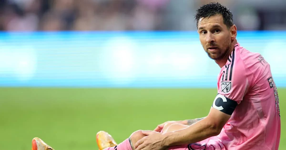 Player sitting on field during match in pink jersey Player sitting on field during match in pink jersey