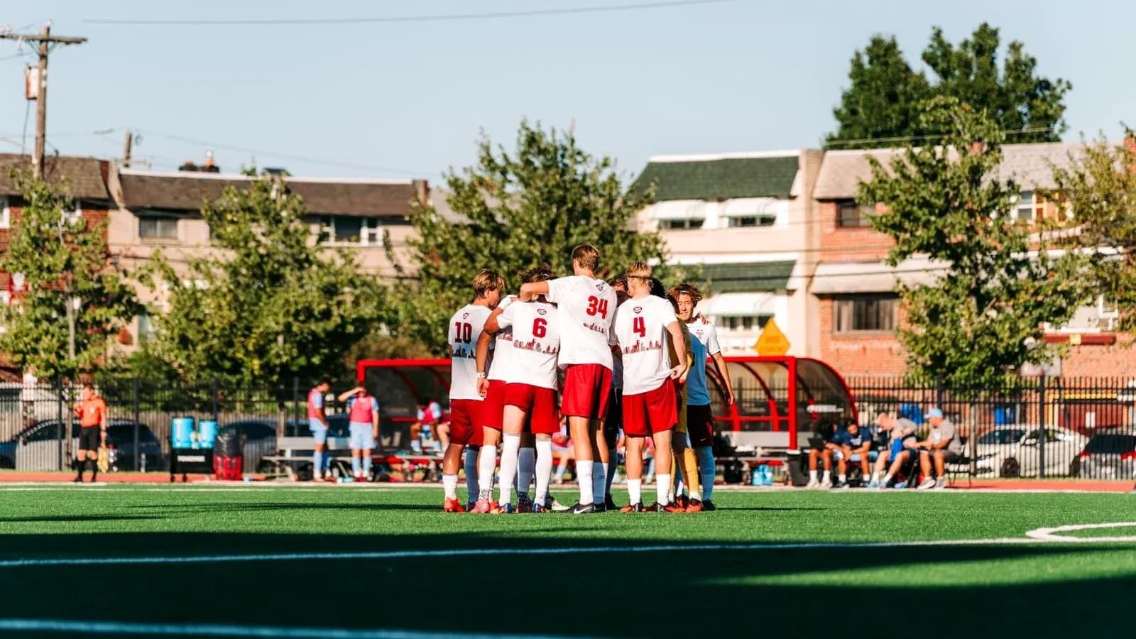 Team huddling before a match on the field Team huddling before a match on the field