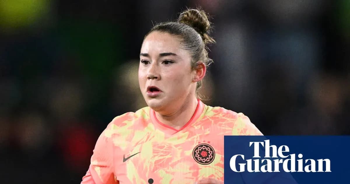 Goalkeeper in pink kit during match action Goalkeeper in pink kit during match action