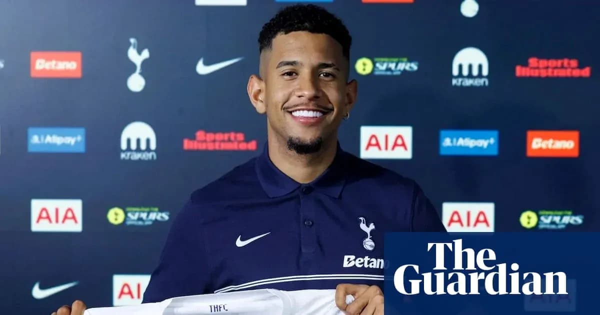 Player holding Tottenham Hotspur jersey at press event Player holding Tottenham Hotspur jersey at press event