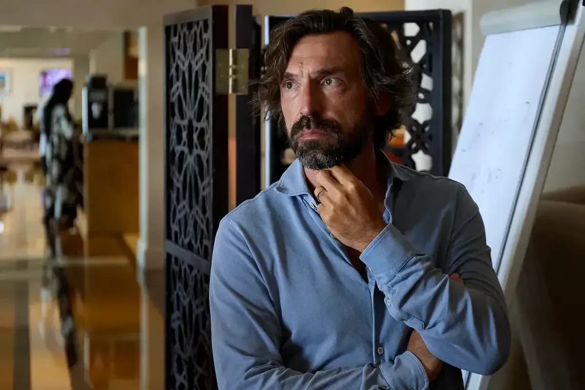 Man in a blue shirt standing thoughtfully indoors Man in a blue shirt standing thoughtfully indoors