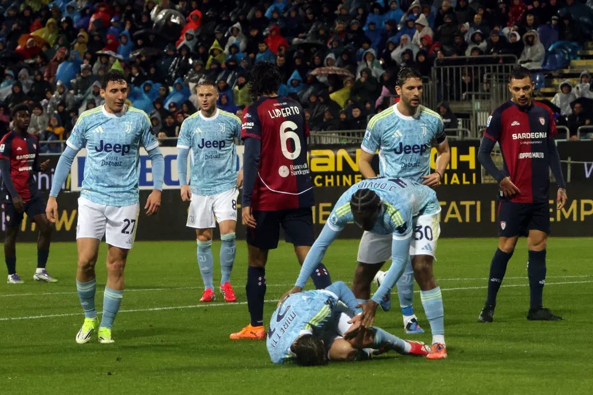 Juventus players attending to an injured teammate Juventus players attending to an injured teammate