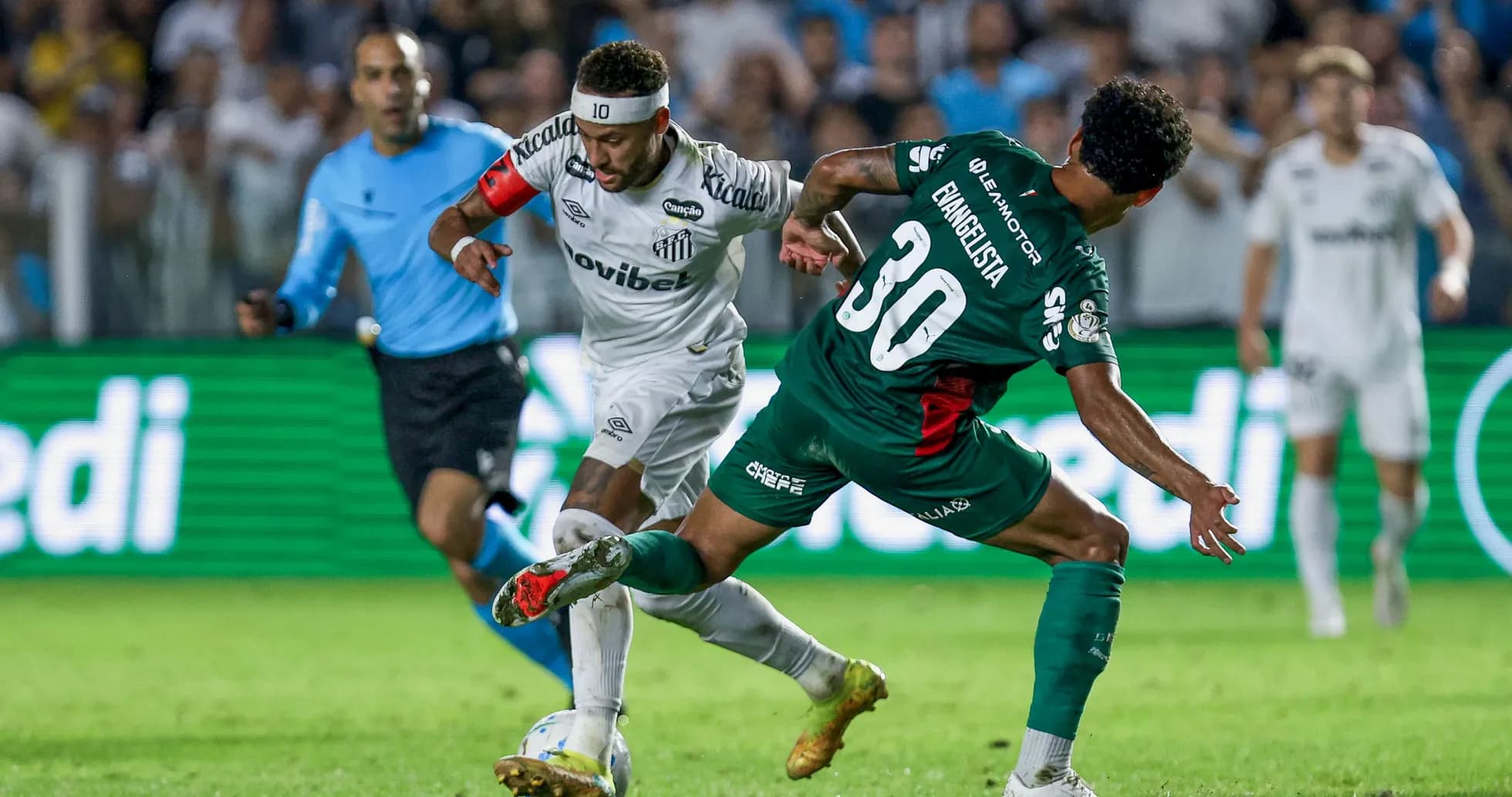 Player in white dribbling past opponent in green Player in white dribbling past opponent in green