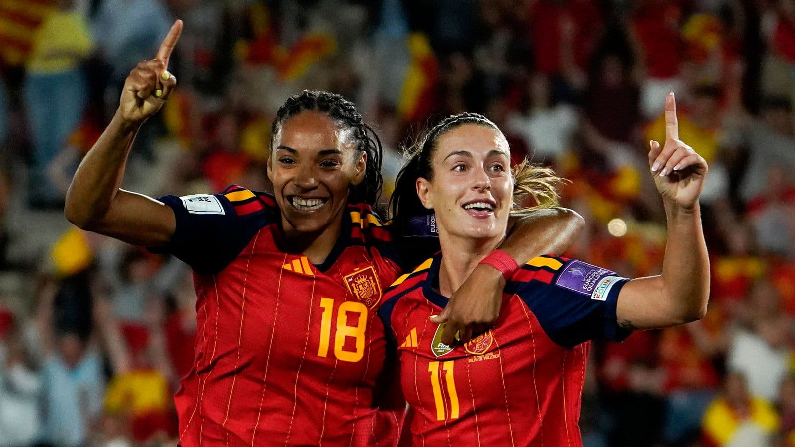 Two Spain players celebrating a goal together Two Spain players celebrating a goal together