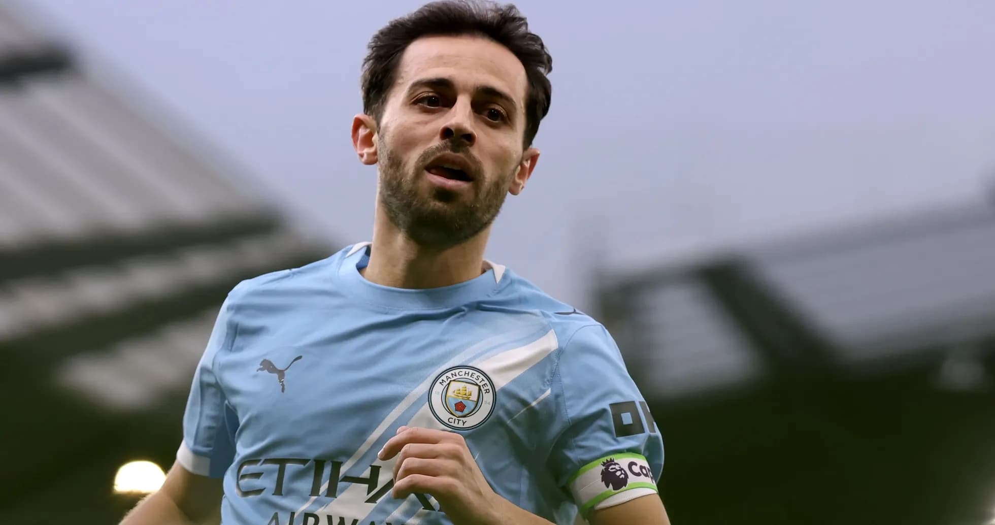 Player in Manchester City kit running on the pitch Player in Manchester City kit running on the pitch