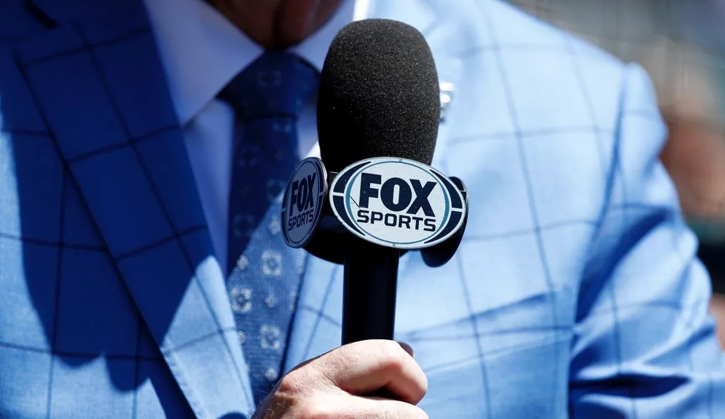 Microphone with FOX Sports logo held by a person Microphone with FOX Sports logo held by a person