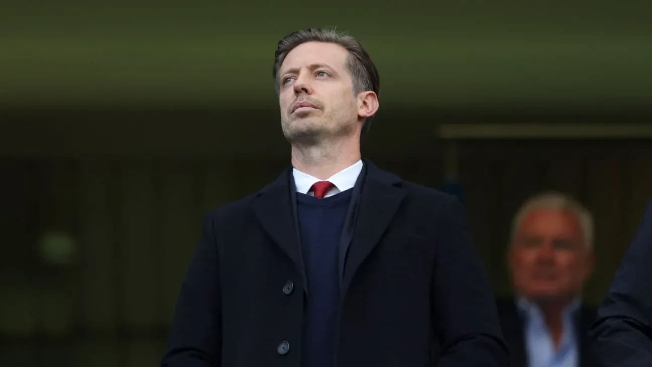 Man in suit observing from the stands Man in suit observing from the stands