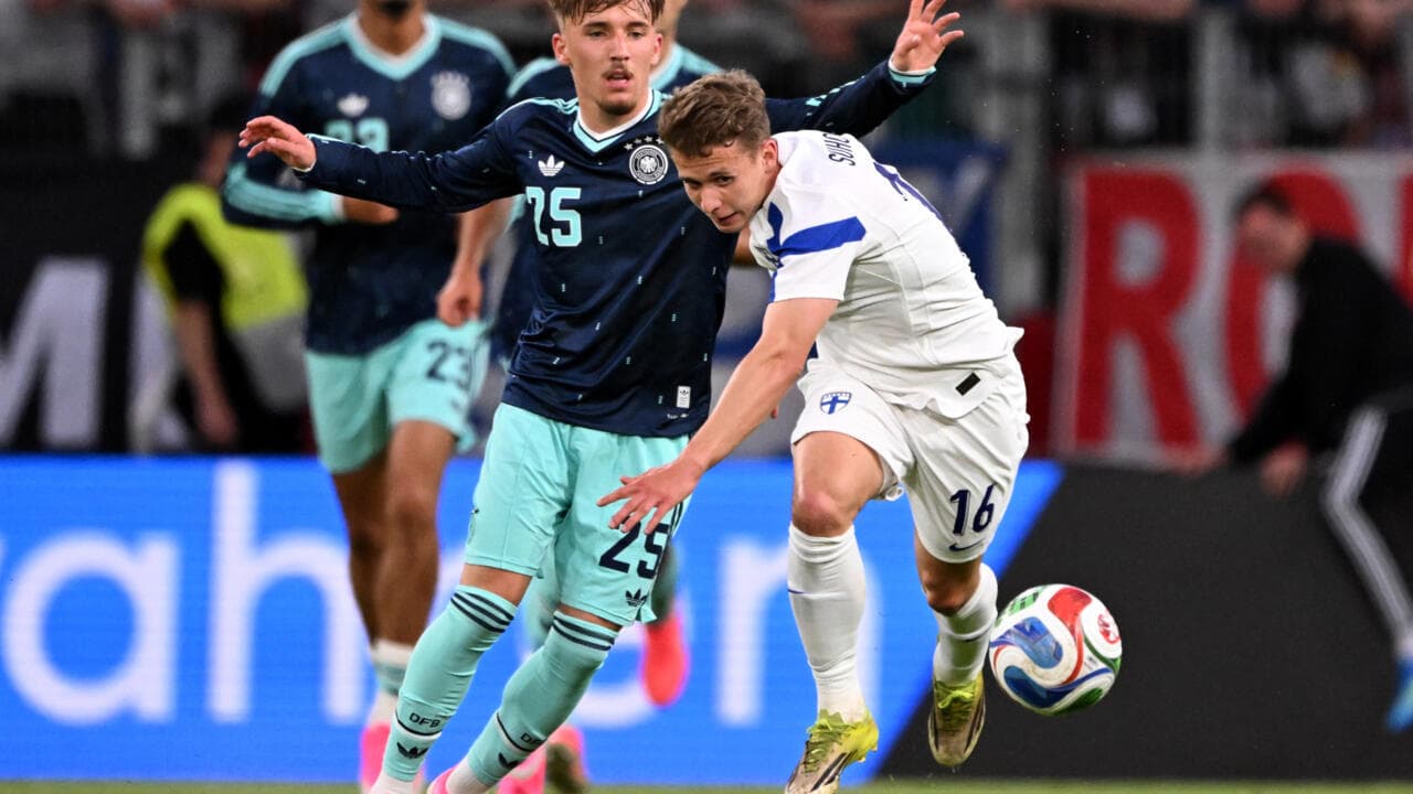 Players competing for the ball during a match Players competing for the ball during a match