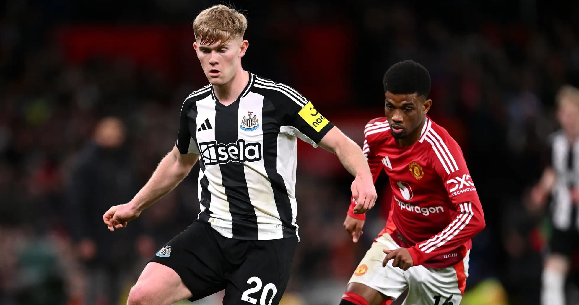 Newcastle player dribbling past Manchester United opponent Newcastle player dribbling past Manchester United opponent