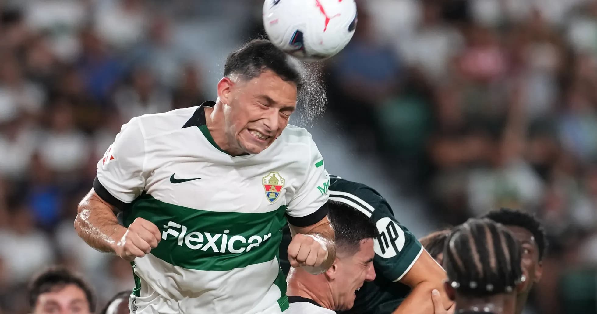 Player heading the ball during match action Player heading the ball during match action